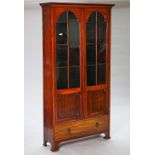 An early 20th century mahogany floorstanding display cabinet with a pair of three quarters...