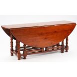 An 18th century style yew wood drop flap wake table on turned supports, 198cm long x 153cm...