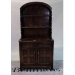 A modern oak dresser with two tier arch top back, over the base with a pair of drawers and...