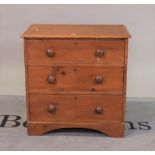 An early 20th century pine chest of three long drawers