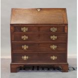 A George III mahogany bureau with four long graduated drawers on bracket feet