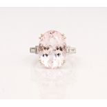 An 18ct white gold, morganite and diamond ring, claw set with the oval cut morganite between...