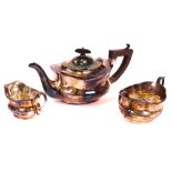 A silver three piece tea set, comprising; a teapot with ebonised fittings, a twin handled...