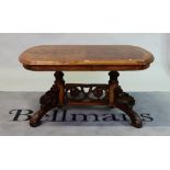 A Victorian burr walnut oval low table with pierced stretcher on four carved outswept supports