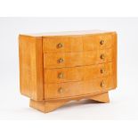 An Art Deco birch bowfront three drawer commode on sloped plinth base, 120cm wide x 93cm high.