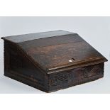 A 17th century oak slope front bible box with carved frieze, 55cm wide; 27cm high