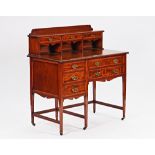 An Edwardian inlaid mahogany writing desk, with fitted three drawer superstructure over five...