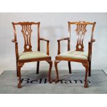 A pair of George III style mahogany open armchairs on ball and claw supports