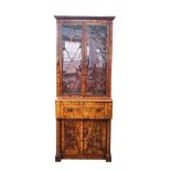 A Regency mahogany secretaire bookcase, the pair of astragal glazed doors over fitted drawer...