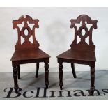 A pair of Victorian style mahogany hall chairs on turned supports (2)