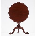 An 18th century mahogany occasional table, the snap pie-crust top on spiral column and tripod...
