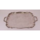 A silver shaped rectangular twin handled tray, having a raised rim, length including handles...