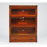 The Globe-Wernicke Co. Ltd, a mahogany glazed three section bookcase on a single drawer base,...