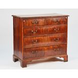 A George III mahogany chest with two short and three long graduated drawers on bracket feet,...