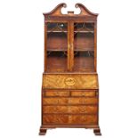 A George III inlaid mahogany bureau bookcase with swan neck cornice over astragal glaze door,...