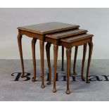 A Victorian style walnut nest of three tables