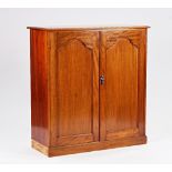 A George III style mahgoany side cabinet, the arch panel doors enclosing a fitted interior, on...