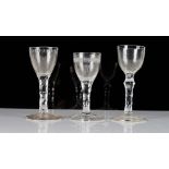 Three facet stemmed wine glasses, late 18th century, one engraved with the initial `H' beneath...