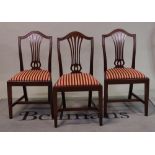 A set of six George III style mahogany pierced splat back dining chairs, on square supports,