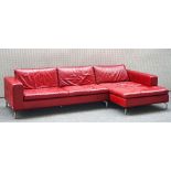 Natuzzi, a red leather upholstered modular corner sofa on chrome supports, 310cm x 160cm wide.