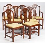 A set of eight George III style mahogany dining chairs with pierced splat on canted square...