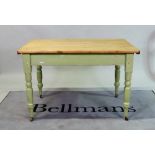 A late Victorian green painted pine kitchen table on turned supports