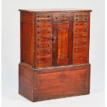 A made-up 19th century mahogany cabinet with an arrangement of seventeen drawers and cupboards...