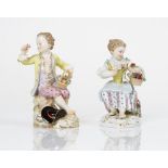 A pair of Meissen figures of a seated boy and girl holding baskets of flowers, late 19th...