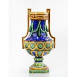 A Minton majolica two-handled vase, circa 1871, the neck applied with green laurel swags...