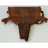 A shoulder bag made from a complete cayman, cured to include head and feet,