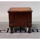 A 19th century mahogany commode with inset leather top on turned supports