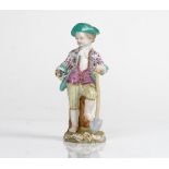 A Meissen figure of a boy gardener, 19th century, modelled standing with one foot resting on a...
