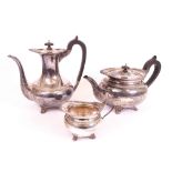 A silver three piece part tea and coffee set, comprising; a teapot with black fittings, a...