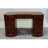 A 19th century mahogany writing desk with tooled leather top over nine drawers