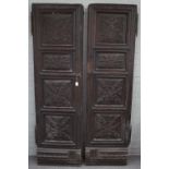 A pair of 18th century Flemish oak armoire doors, each with four foliate carved raised and...