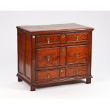 A late 17th century oak chest of three long drawers, on stile feet, 101cm wide x 85cm high.