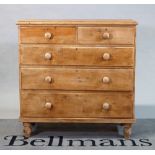 A Victorian pine desk of two short and three long graduated drawers on turned feet