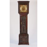 A carved oak eight-day longcase clock