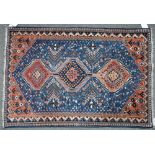 A South Persian rug, the indigo field with an indigo and two madder medallions, minor motifs,...