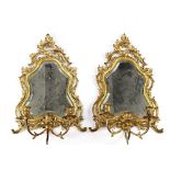 A pair of Louis XV style ormolu mirrored three-branch wall lights