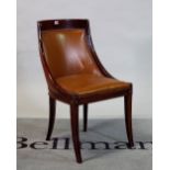 A Regency style mahogany and brown leather tub chair