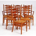 A set of six mid-20th century yew and oak dining chairs with pierced ladder backs on splayed...