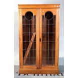 A 20th century oak two door glazed bookcase