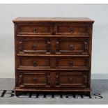 A Charles II style oak desk of two short and three long geometric moulded drawers