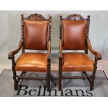 A pair of Victorian oak high back open armchairs on block supports