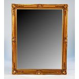 A pair of modern gilt shaped rectangular mirrors, (2)