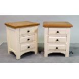 A pair of modern white painted bedside chests with oak tops over three drawers