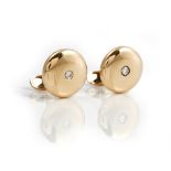 A pair of gold and diamond single stone dress cufflinks, each domed circular front mounted...