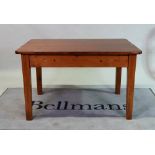 An early 20th century pine kitchen table on tapering square supports