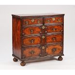 A Charles II and later yew chest of two short and three long geometric drawers, on bun feet,...
